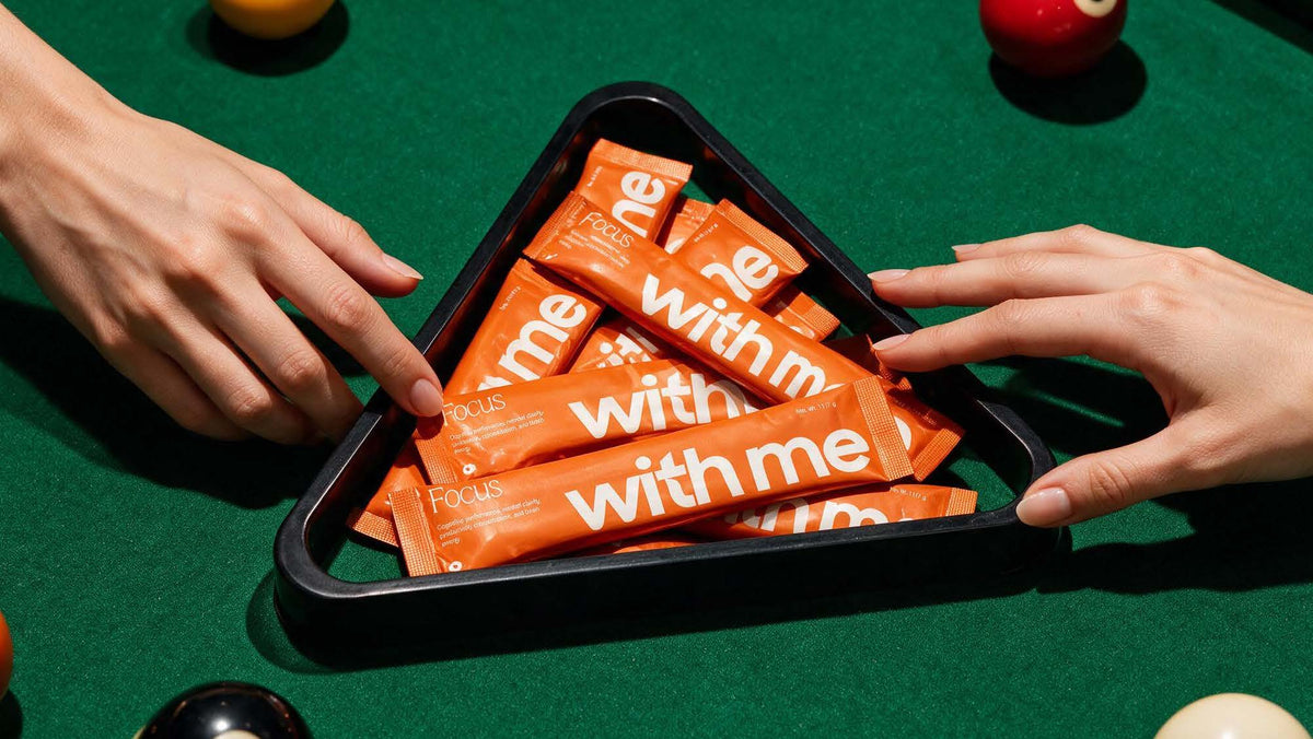 Orange Focus stick packs racked in a pool triangle on green felt